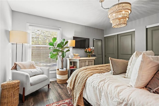 bedroom featuring an inviting chandelier and dark hardwood / wood-style floors