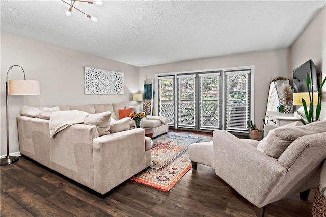 living room with dark hardwood / wood-style floors and a textured ceiling