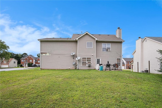 1135 Misty Meadows Way, Hampton, GA 30229 - rear view of property with a lawn, a chimney, and a patio