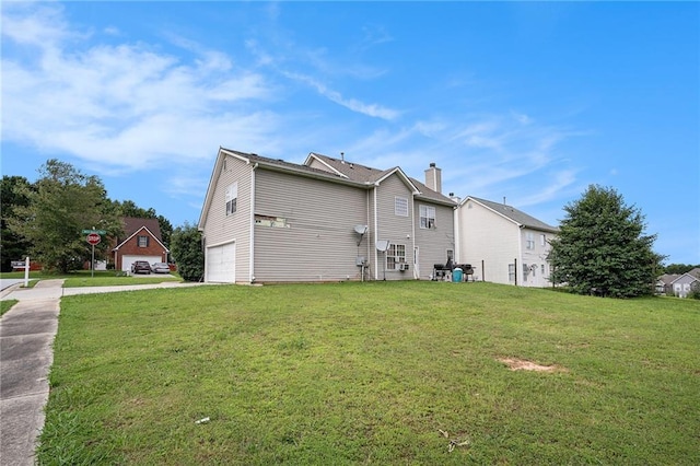 1135 Misty Meadows Way, Hampton, GA 30229 - back of house featuring a garage, concrete driveway, a yard, and a chimney
