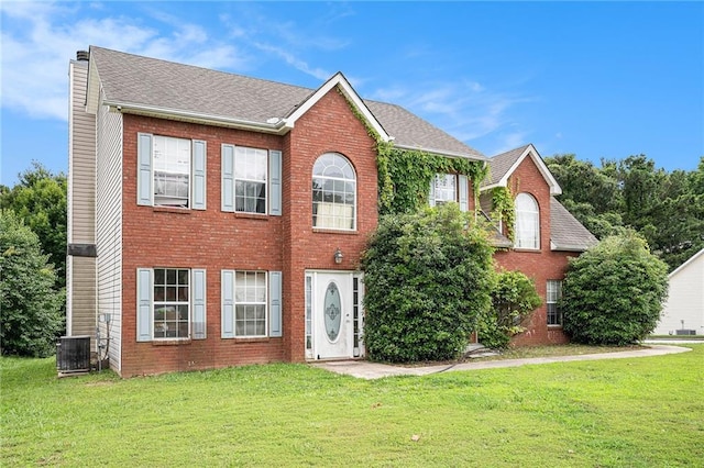 1135 Misty Meadows Way, Hampton, GA 30229 - colonial home with a front lawn, brick siding, a chimney, and roof with shingles