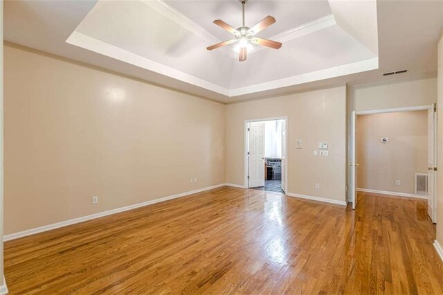 5170 Stone Croft Trl, Atlanta, GA 30331 - empty room featuring a tray ceiling, ceiling fan, and light hardwood / wood-style flooring