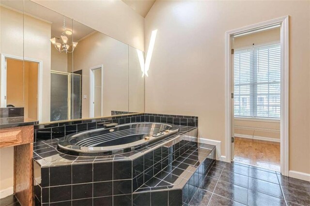 5170 Stone Croft Trl, Atlanta, GA 30331 - bathroom featuring a wealth of natural light, tile patterned flooring, lofted ceiling, and a notable chandelier