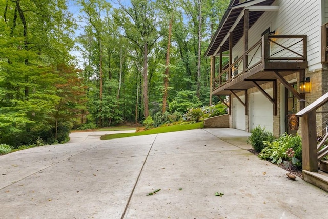 1461 Bubbling Creek Rd NE, Brookhaven, GA 30319 - view of property exterior with a garage, concrete driveway, and a balcony