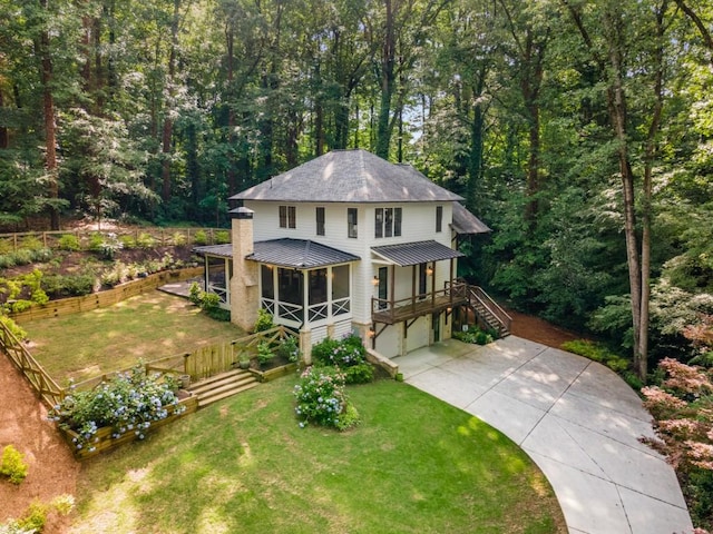 1461 Bubbling Creek Rd NE, Brookhaven, GA 30319 - view of front of house featuring stairway, driveway, a sunroom, a front lawn, and a view of trees