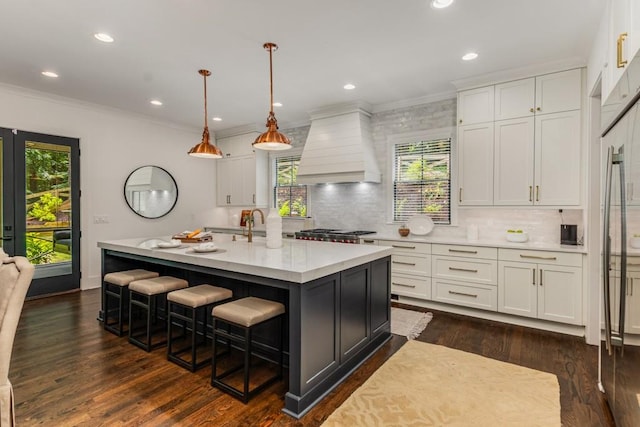 1461 Bubbling Creek Rd NE, Brookhaven, GA 30319 - kitchen with premium range hood, light countertops, plenty of natural light, crown molding, and white cabinets