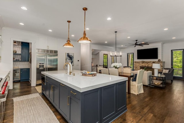 1461 Bubbling Creek Rd NE, Brookhaven, GA 30319 - kitchen with built in fridge, a sink, a ceiling fan, wine cooler, and light countertops