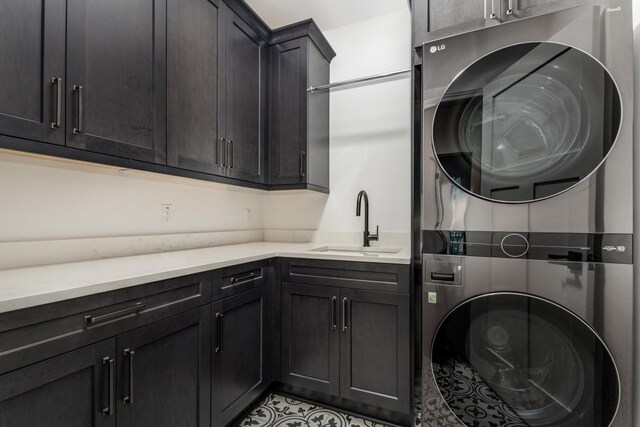 1461 Bubbling Creek Rd NE, Brookhaven, GA 30319 - laundry room featuring estacked washer and dryer, cabinet space, and light tile patterned flooring
