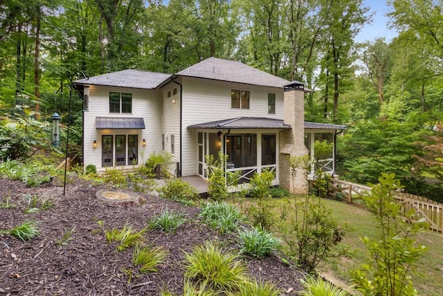 1461 Bubbling Creek Rd NE, Brookhaven, GA 30319 - back of house featuring a sunroom, view of wooded area, and a shingled roof