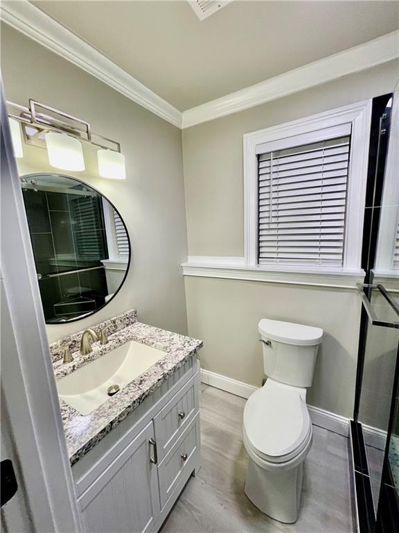 2694 Tritt Springs Dr NE, Marietta, GA 30062 - bathroom with ornamental molding, vanity, toilet, baseboards, and a shower