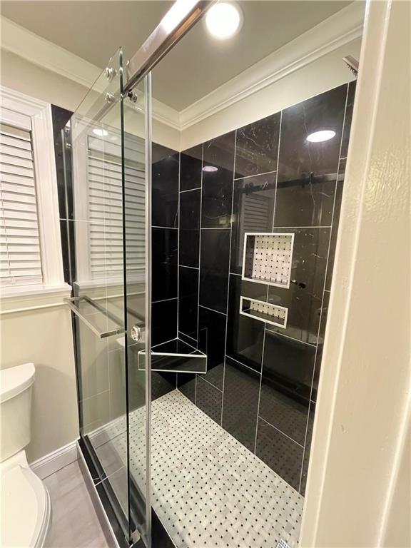 2694 Tritt Springs Dr NE, Marietta, GA 30062 - full bath with toilet, a stall shower, ornamental molding, and baseboards