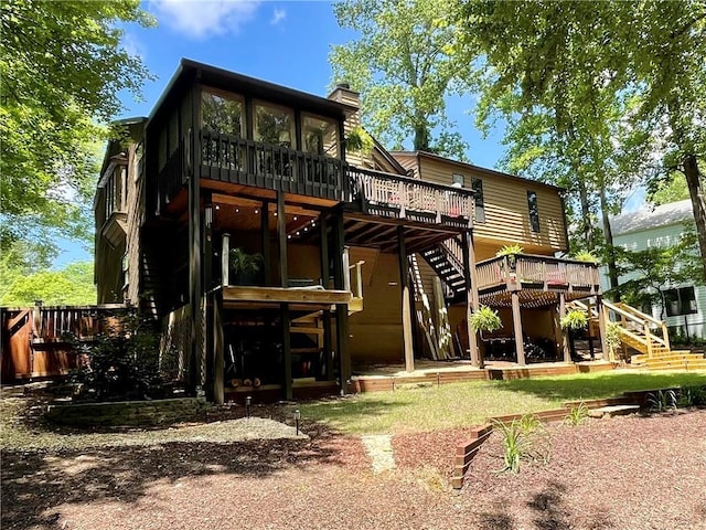 2694 Tritt Springs Dr NE, Marietta, GA 30062 - back of house featuring stairway, a deck, a chimney, and a sunroom