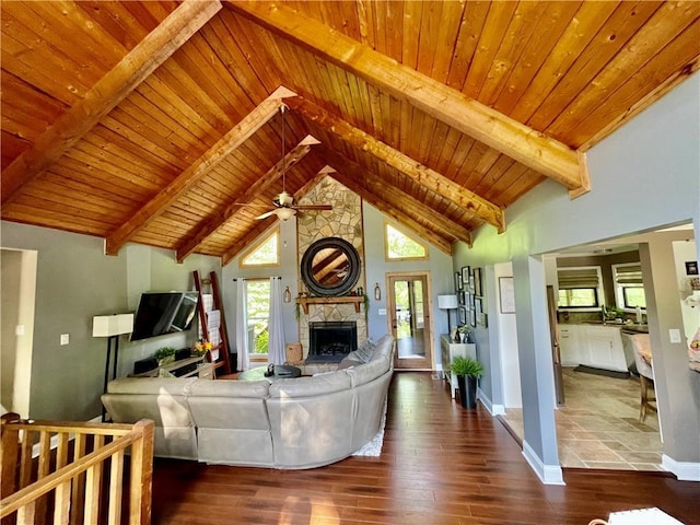 2694 Tritt Springs Dr NE, Marietta, GA 30062 - living room featuring a stone fireplace, wood finished floors, a ceiling fan, wood ceiling with exposed beams, and baseboards