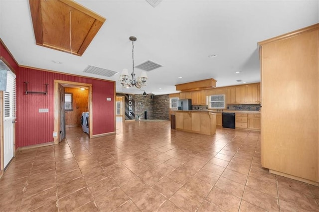 kitchen featuring a kitchen island, open floor plan, black dishwasher, stainless steel fridge, and a chandelier