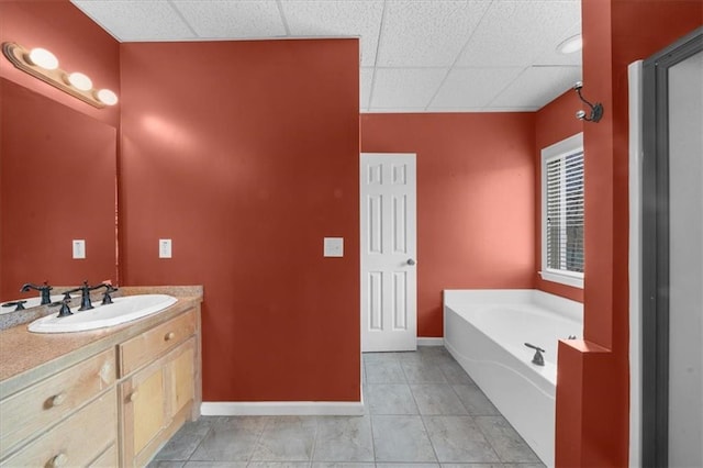 full bath with vanity, tile patterned floors, a bath, and baseboards