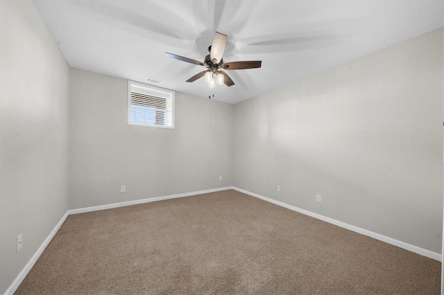 empty room with visible vents, carpet flooring, baseboards, and ceiling fan