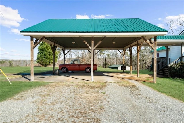 view of parking featuring a detached carport and dirt driveway