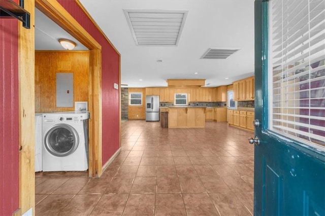 interior space featuring washer / dryer, electric panel, visible vents, and tile patterned floors