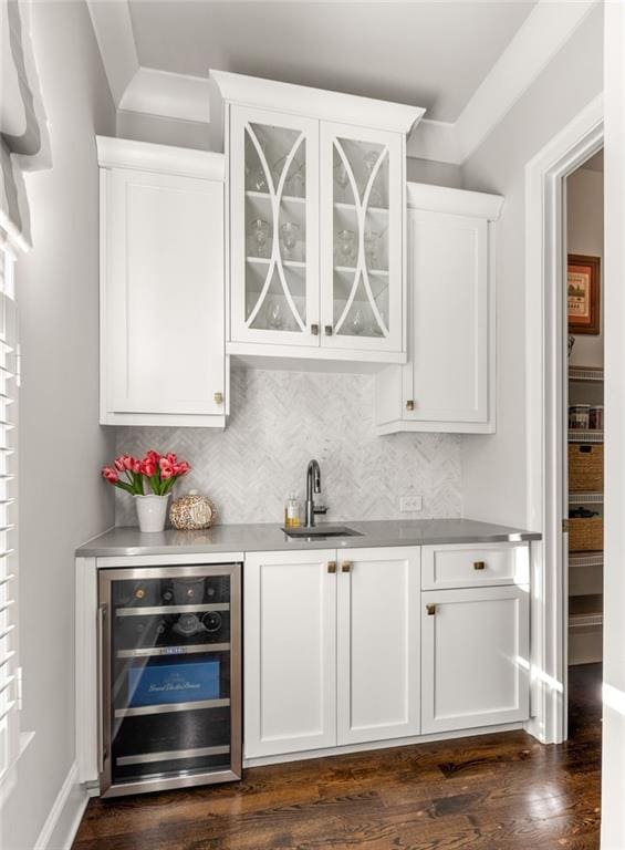 bar with sink, dark hardwood / wood-style floors, wine cooler, tasteful backsplash, and white cabinets