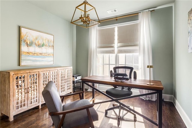 office space with dark hardwood / wood-style flooring and a notable chandelier