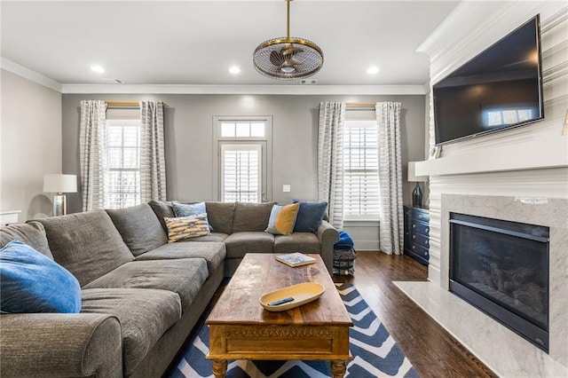 living room featuring ornamental molding, a healthy amount of sunlight, and dark hardwood / wood-style floors