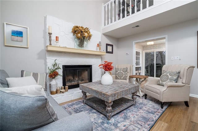 living room with hardwood / wood-style flooring and a fireplace