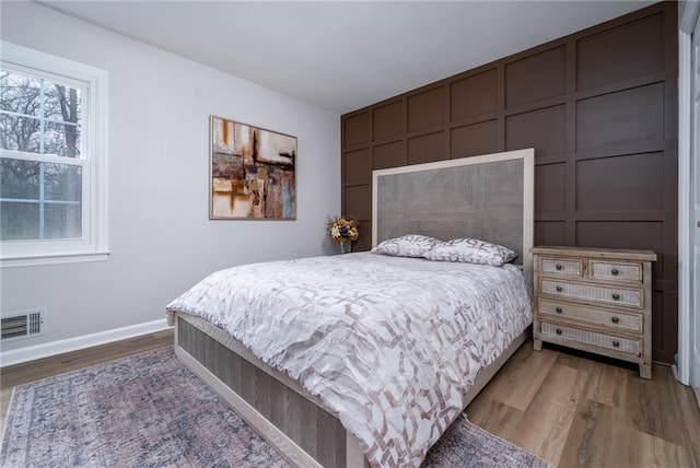 bedroom with wood-type flooring