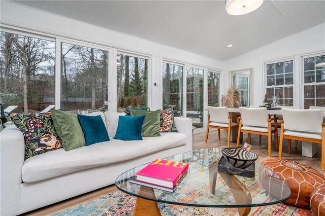 sunroom / solarium featuring vaulted ceiling