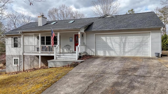 ranch-style home featuring a chimney, a porch, driveway, and an attached garage
