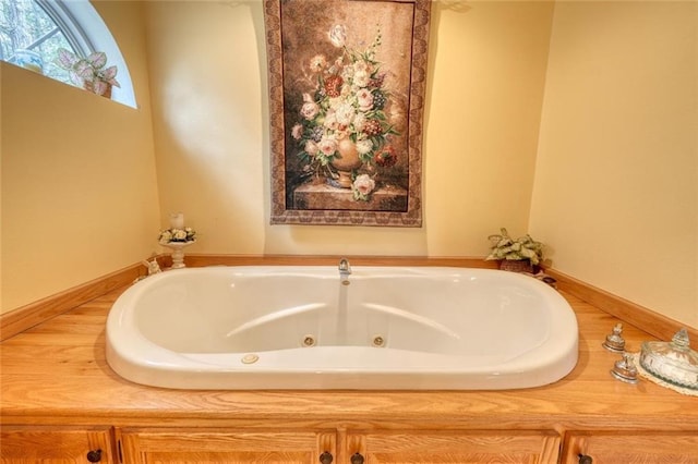 full bath featuring a tub with jets