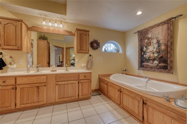 full bath with tile patterned floors, double vanity, a sink, and a garden tub