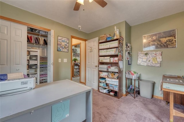 home office featuring ceiling fan and carpet
