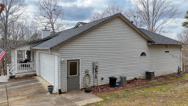 view of property exterior with driveway, a chimney, a garage, and a shingled roof