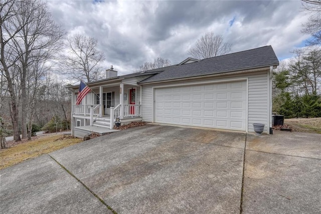 single story home with a chimney, a shingled roof, an attached garage, and concrete driveway