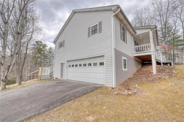 view of home's exterior with a garage and aphalt driveway