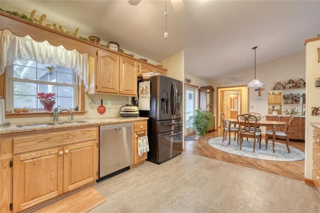 kitchen with refrigerator with ice dispenser, a sink, decorative light fixtures, vaulted ceiling, and stainless steel dishwasher