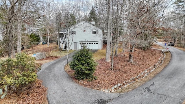 view of front facade featuring aphalt driveway and a chimney