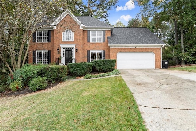 colonial house with a front lawn and a garage