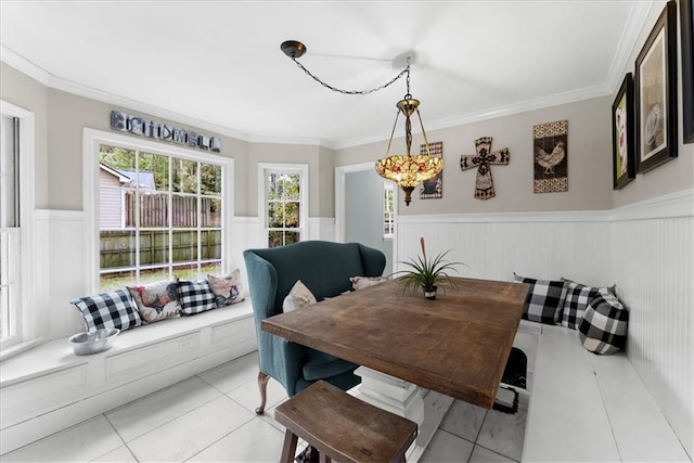 dining room featuring crown molding and light tile patterned floors