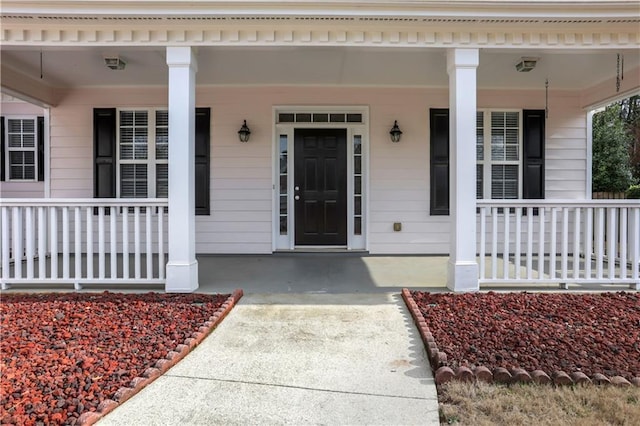 property entrance with covered porch