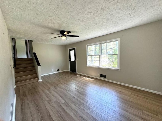 foyer entrance featuring hardwood / wood-style floors, a textured ceiling, and ceiling fan