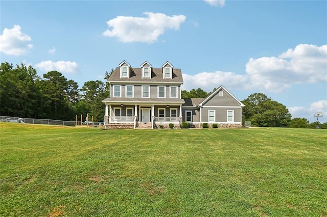 colonial home with covered porch and a front lawn