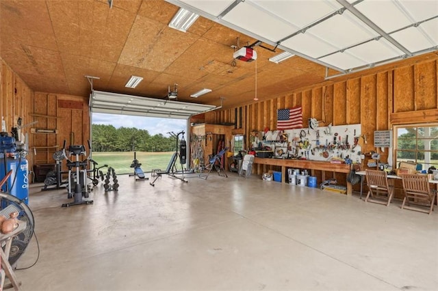 garage with a workshop area and a garage door opener