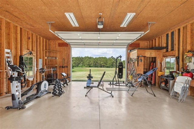 garage featuring wood walls and a garage door opener