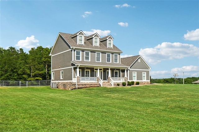 view of front of house featuring a front yard, a porch, and central AC