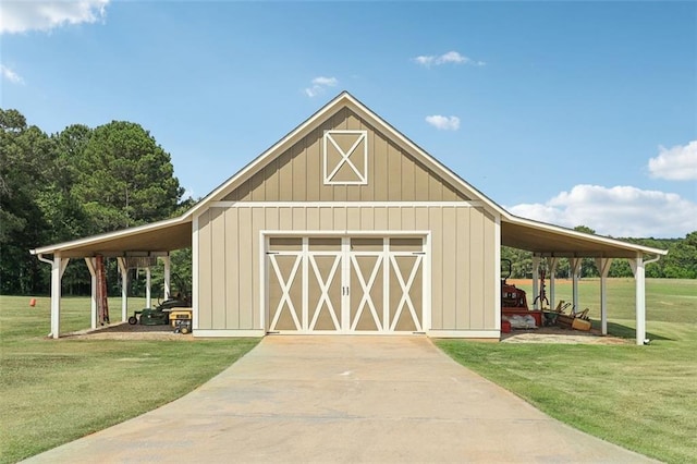 view of outdoor structure with a garage, a lawn, and a carport