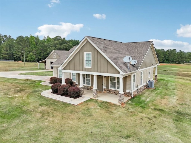 exterior space with a porch, central AC unit, and a lawn