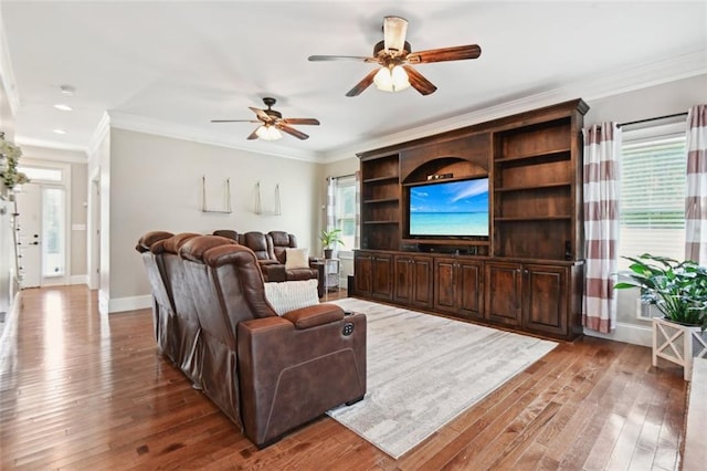 living room featuring hardwood / wood-style flooring, ornamental molding, and ceiling fan