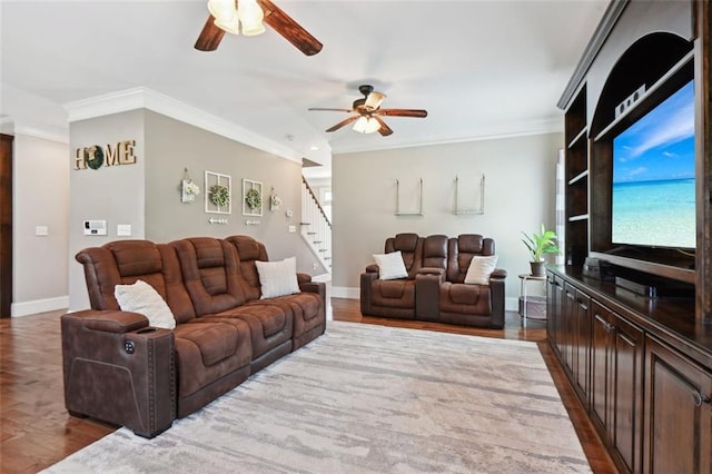 living room featuring ceiling fan, hardwood / wood-style floors, and crown molding