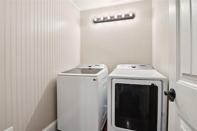 clothes washing area with separate washer and dryer